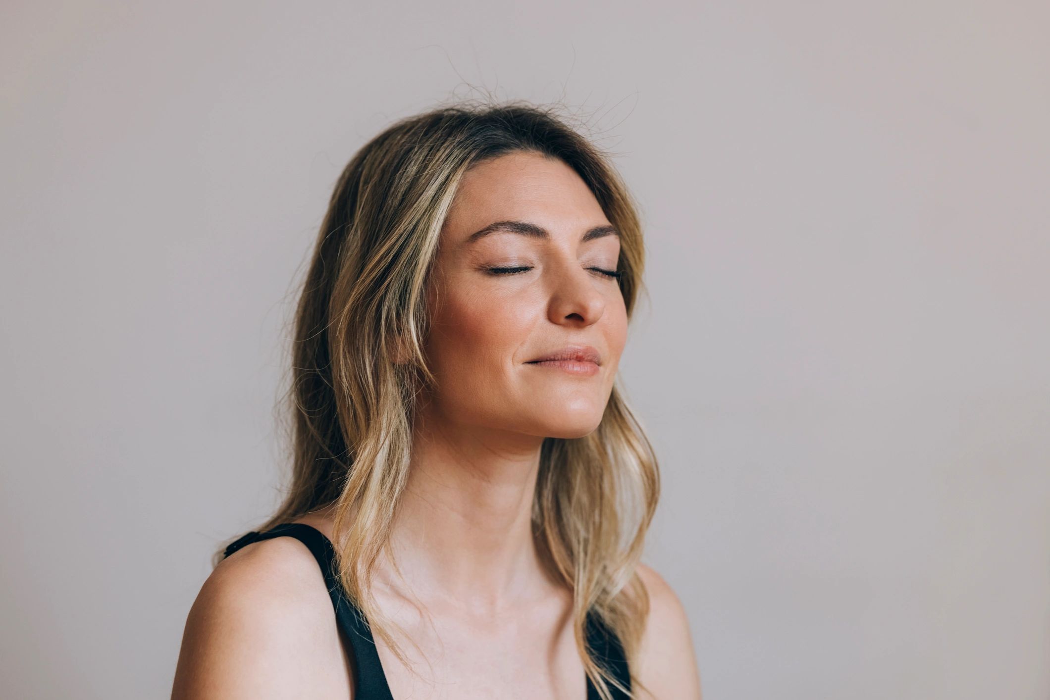 Woman resting with eyes closed, calm and centered